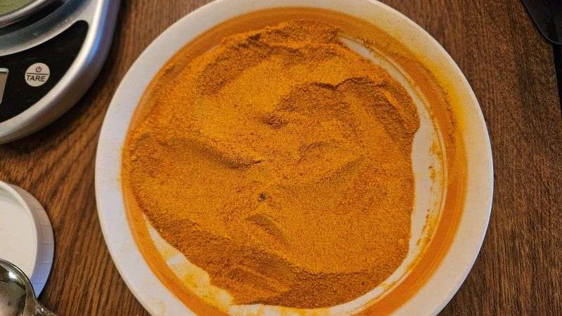 A bowl filled with fine pumpkin powder.