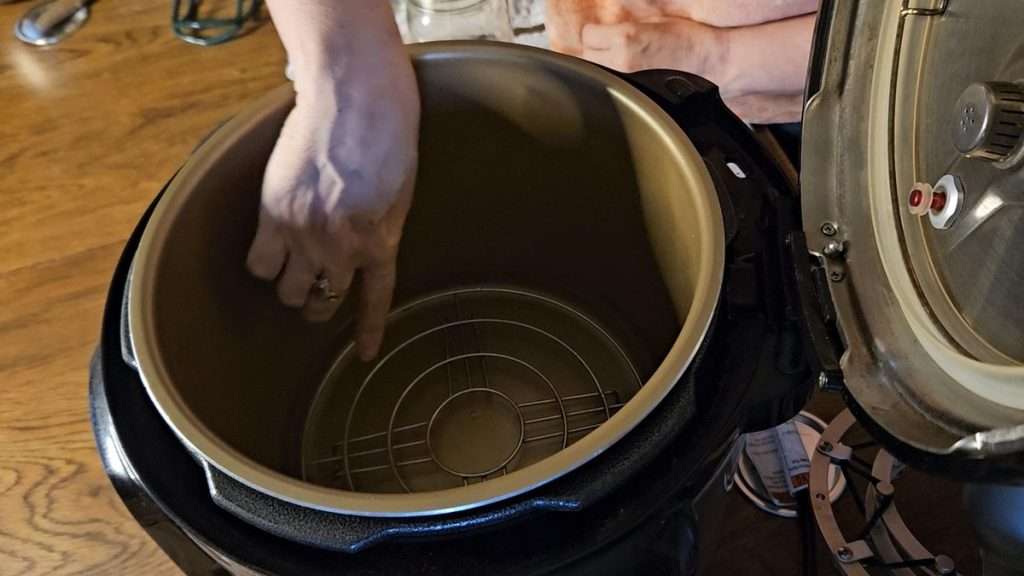 Nesco canner with 4 cups of water in it. The 4 cups of water are below the canning rack, which makes it safe for steam canning.