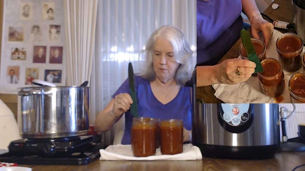 Checking the headspace of the barbecue sauce. it needs to have a half inch headspace.