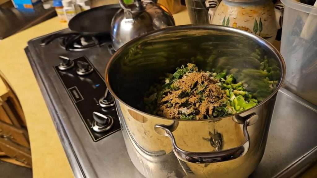 all of the ingredients for canning tomatillo salsa in a large stainless steel stock pot.