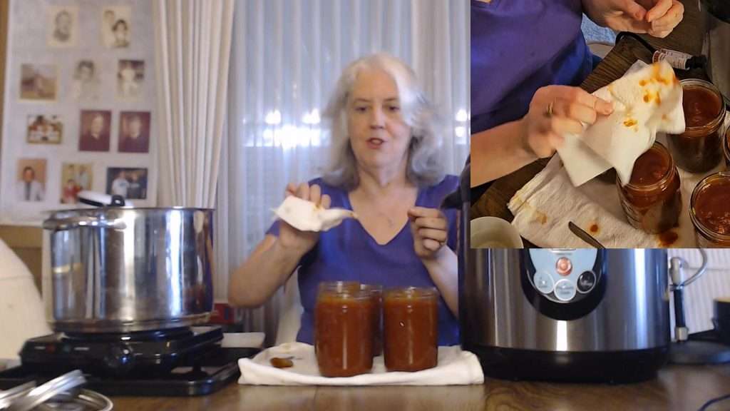 sweet and spicy bbq sauce on a paper towel after wiping the rims of the canning jars.
