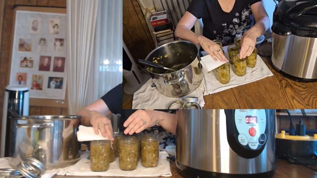 Wiping the mason jar rims with a paper towel that has been dipped in vinegar. 