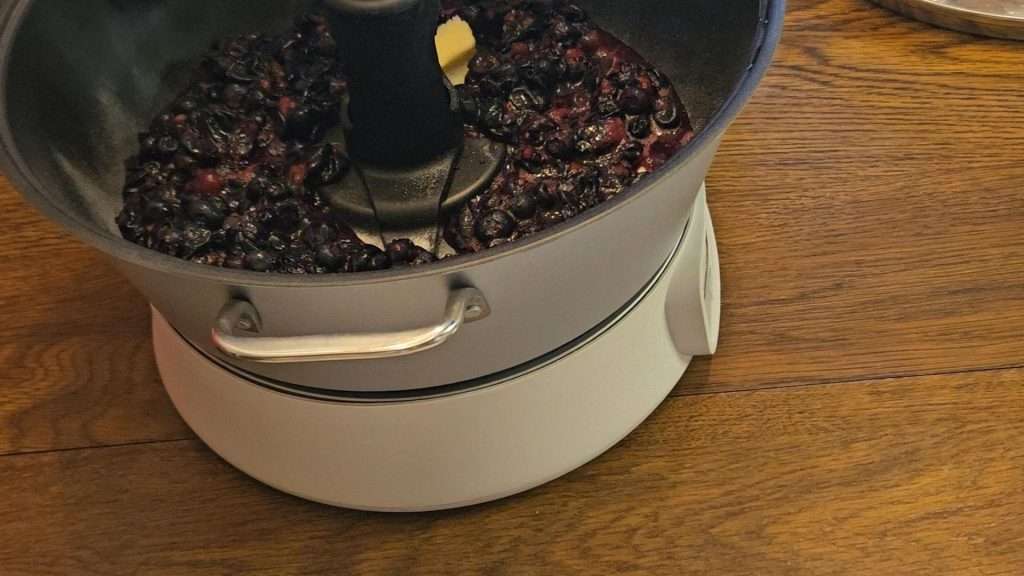 adding butter to the blueberries and pectin