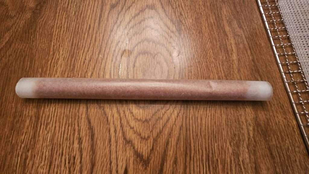 grape fruit leather rolled up in wax paper.