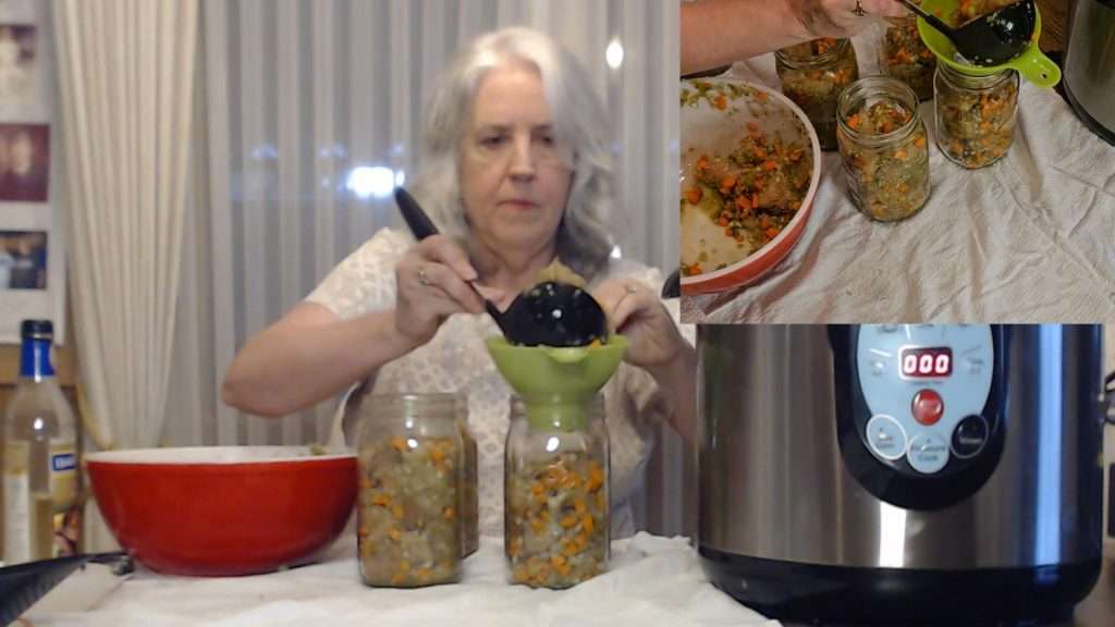 Filling canning jars with the mixture for canning chicken gravy in a jar.