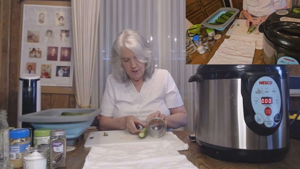 Laying a cucumber next to a canning jar to see how much I needed to cut off.