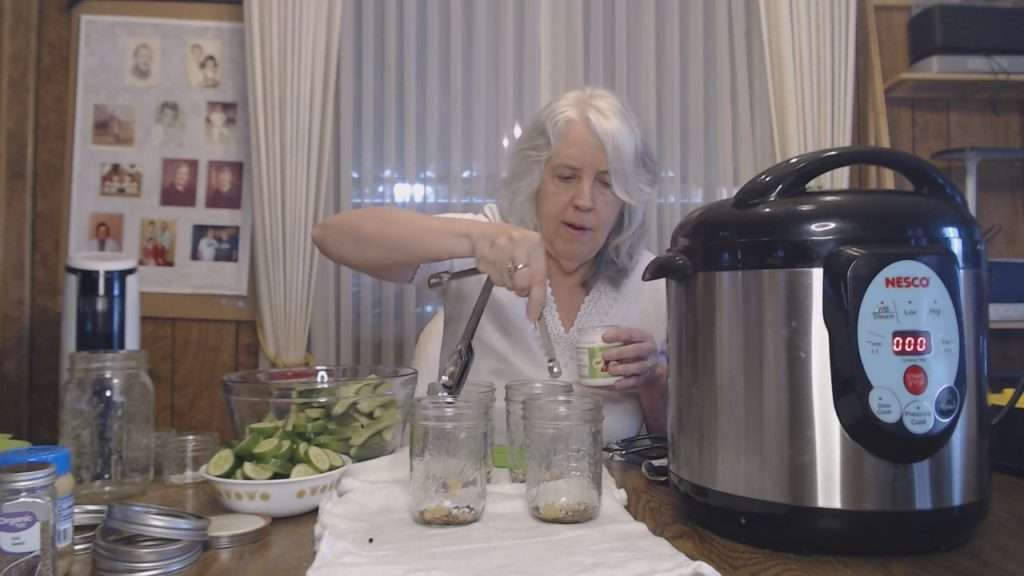 adding pickle crisp to canning jars.