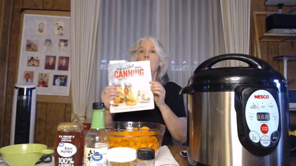 Hold up the all new ball book of canning and preserving, the book that is the source for the recipe for canning honey ginger carrots.
