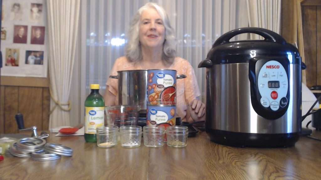 Ingredients for canning pizza sauce - tomato puree, lemon juice, oregano, black pepper, salt, and garlic powder.
