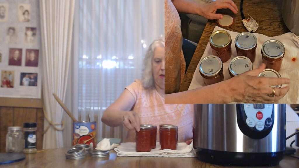 screwing a canning ring on the jars of pizza sauce