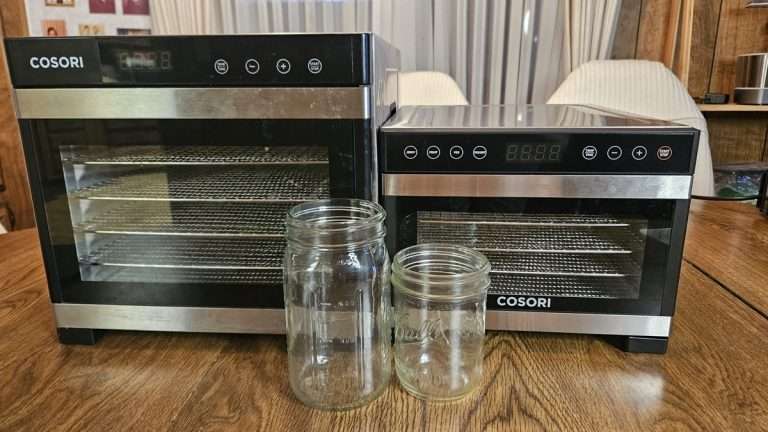 A comparison of the size difference between the 6-tray Cosori Premium stainless steel dehydrator and the Cosori 5-tray mini dehydrator.