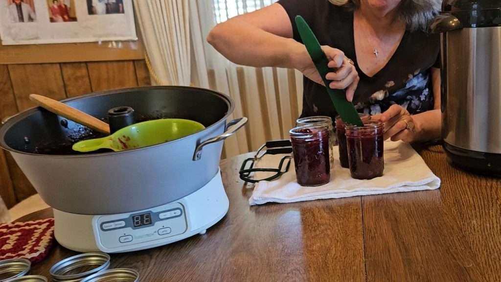 Checking the headspace on jars filled with homemade cranberry sauce.