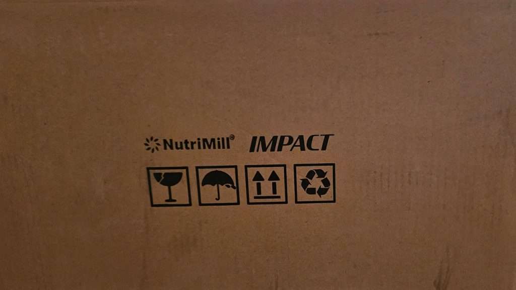 NutriMill Impact box sealed for shipping, showing product name clearly.