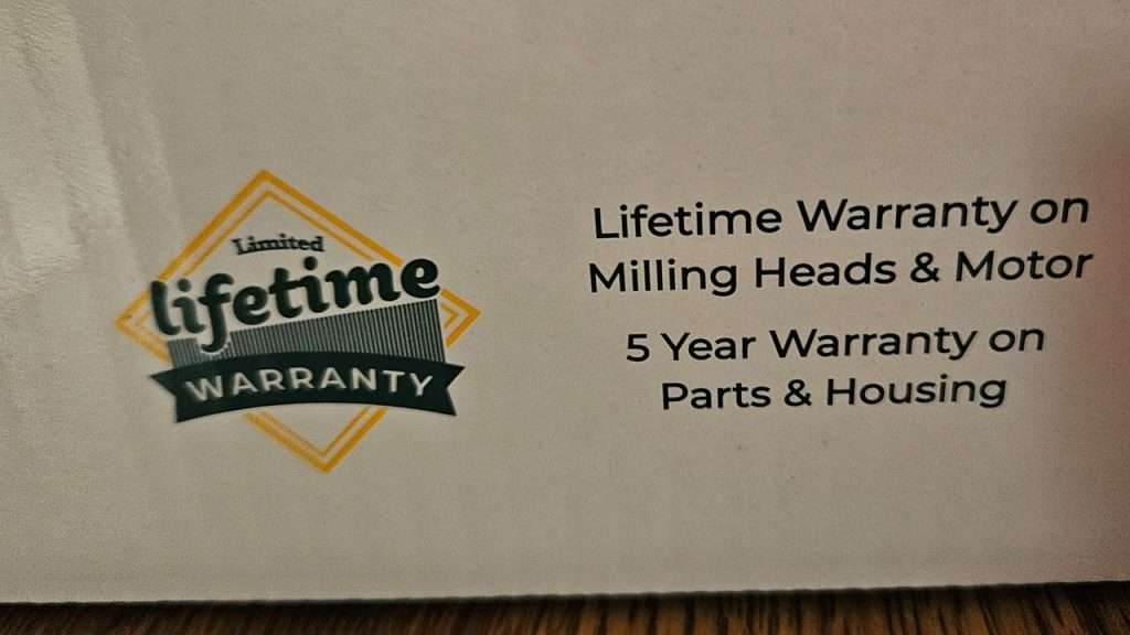 Close-up of warranty statement on the NutriMill Impact grain millbox.
