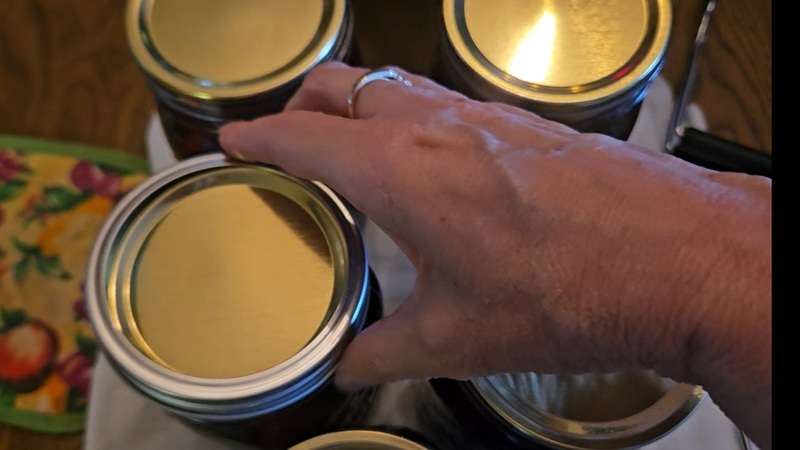 Putting a ring on a canning jar.