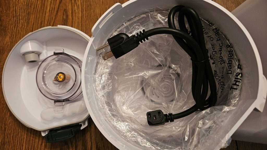 Nutrimill hopper and power cord nestled inside of the flour canister. 