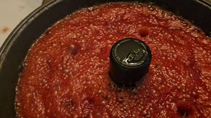 Foaming cherry jam in the jam maker.