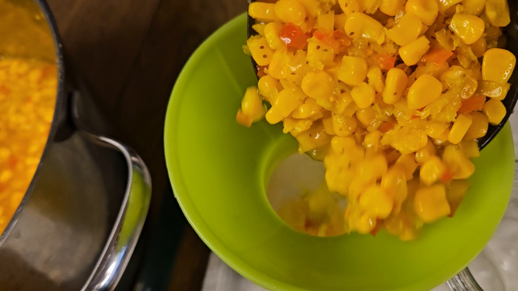 Filling canning jars with corn relish.