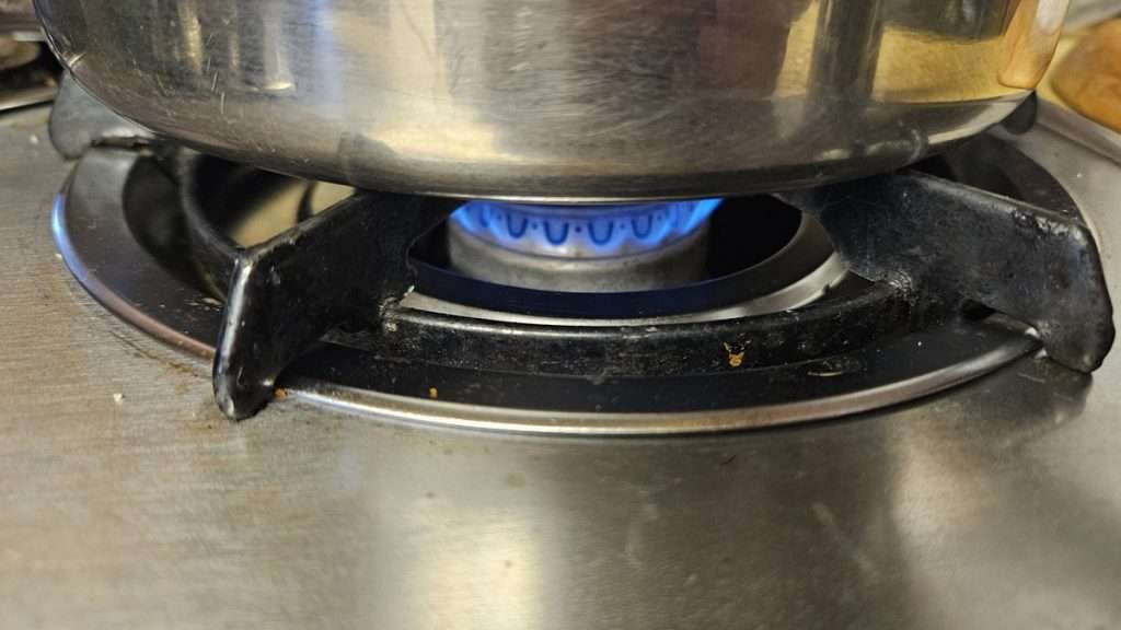 Flame reduced to maintain a simmer.