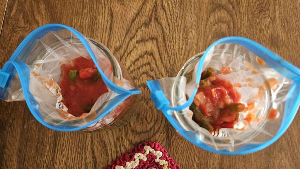 top view of filled freezer bags in mason jars