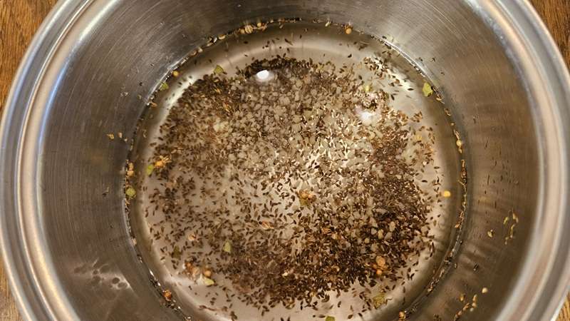 A pot with the brine ingredients, which are all the ingredients for the pickles except the dehydrated cucumbers and salt. 