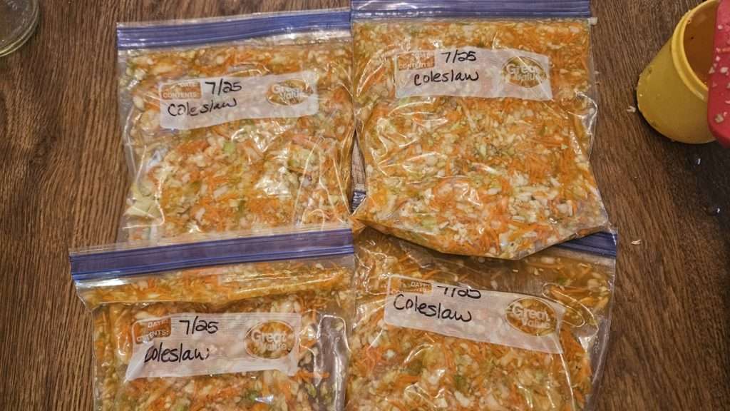 Freezer bags filled with coleslaw, flattened for easy freezing.
