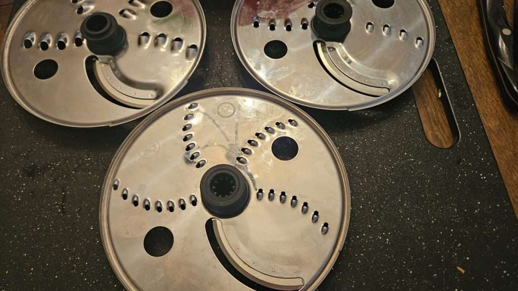 3 food processor shredding discs, fine, medium, and large.