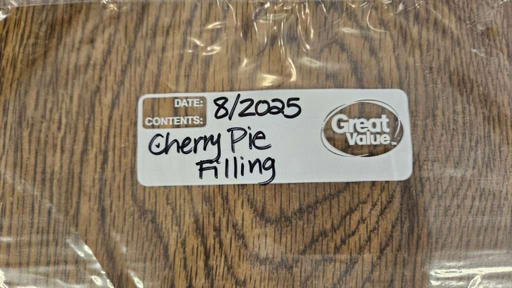 Freezer bag of cherry pie filling labeled and ready for freezing