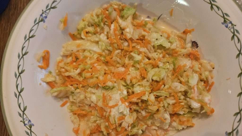 bowl of coleslaw after thawing and mixing with mayonnaise.