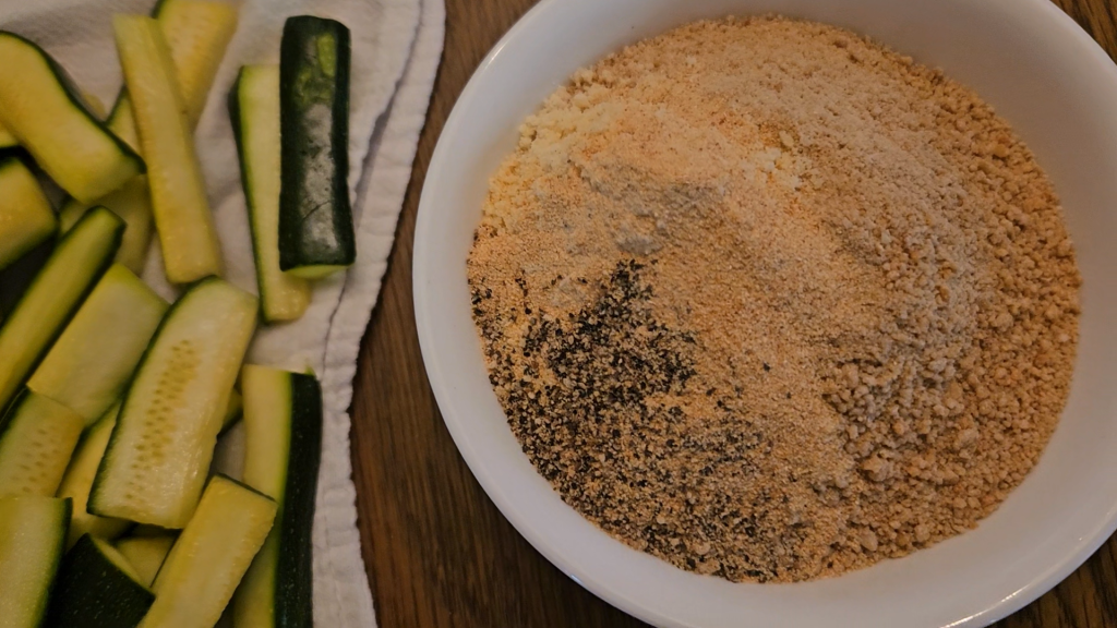 Breadcrumbs with seasonings to coat zucchini (pictured on the left).