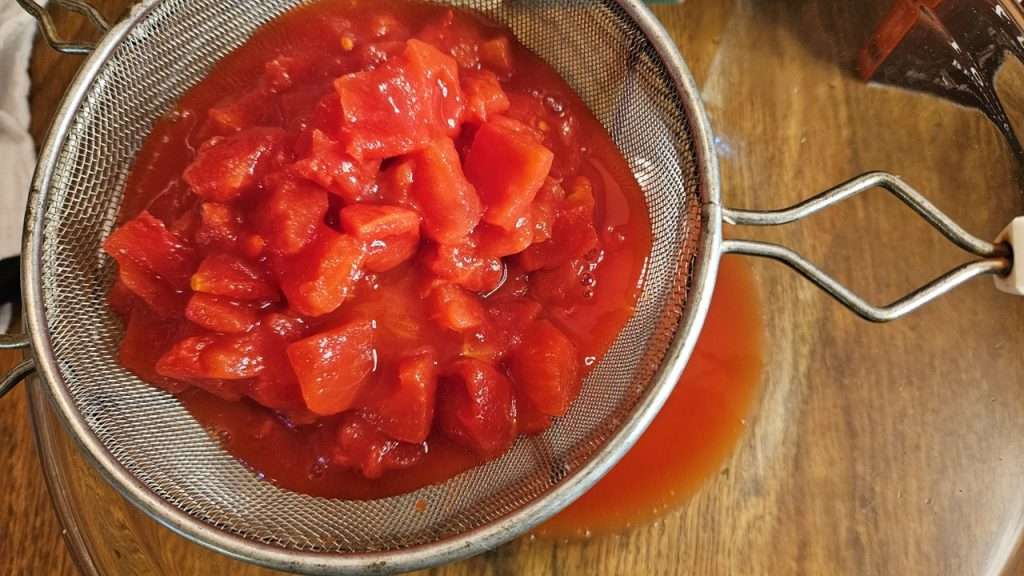 Partially draining canned tomatoes for canning zucchini and tomatoes