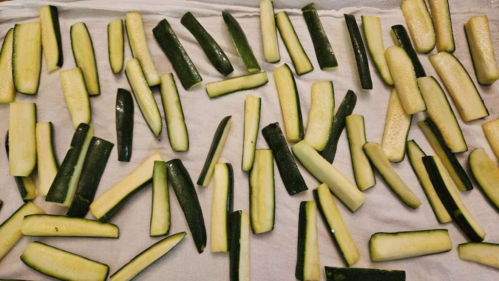 zucchini that has been salted and rinsed, on a flower sack towel to absorb the moisture.