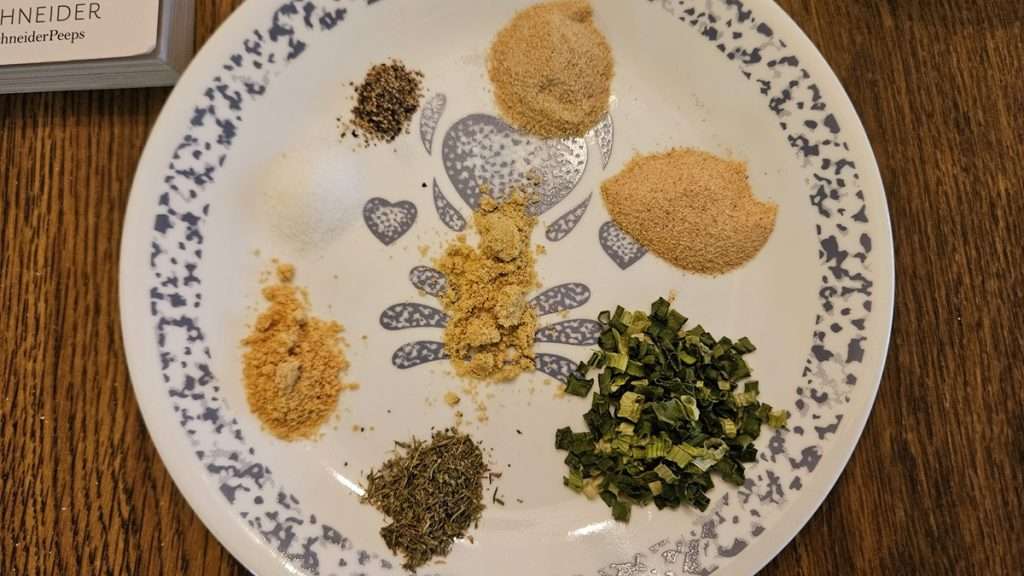 The seasonings for making scalloped potatoes from dehydrated potatoes on a plate.