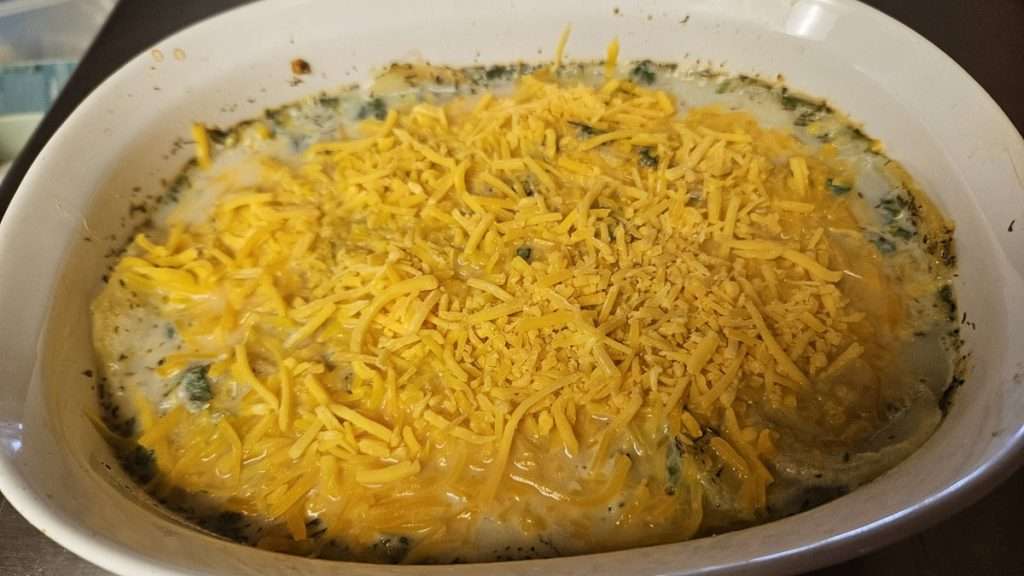 Shredded cheddar cheese on top of the scalloped potatoes.