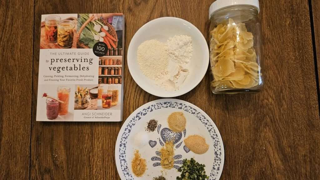 I got the recipe for the scalloped potatoes made from dehydrated potatoes from Angi Schneider's book. Pictured here is the book, a bowl with flour, powdered milk, and cornstarch, a plate with seasonings, and a jar with dehydrated potato slices.