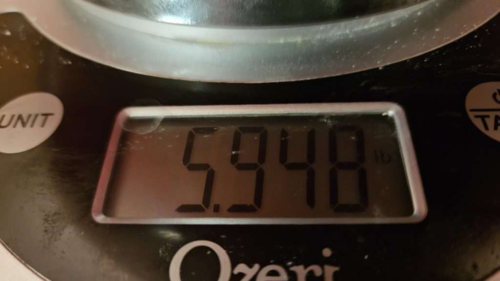 Kitchen scale showing nearly six pounds of russet potatoes for dehydrating.
