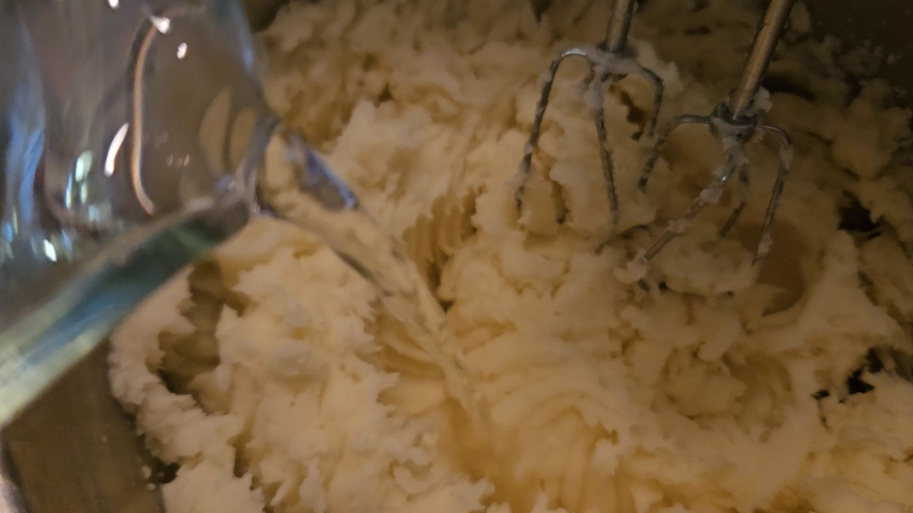 ouring water into mashed potatoes to reach the right consistency for dehydrating.