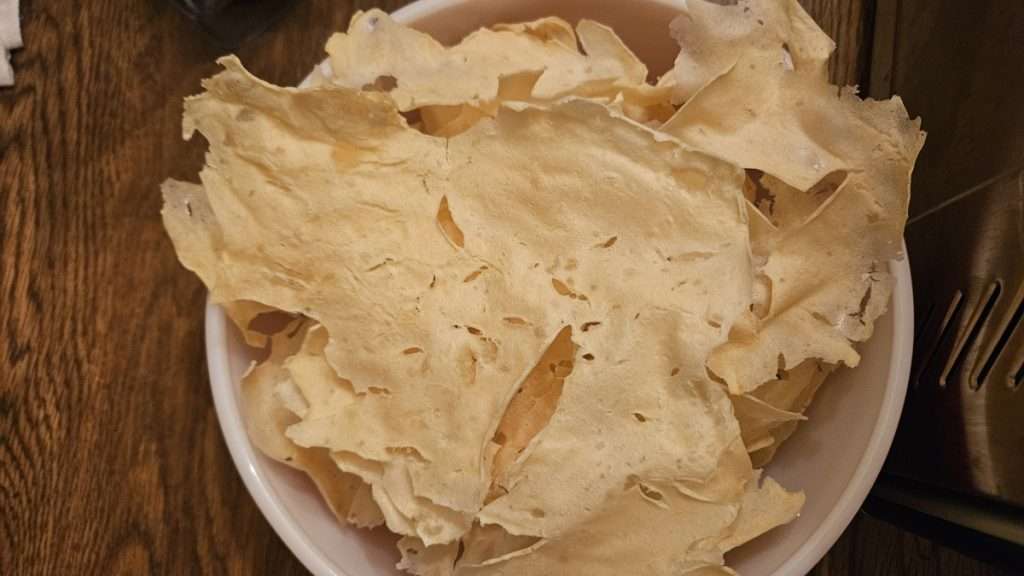 Big chunks of dehydrated mashed potatoes in a mixing bowl before grinding in a blender.