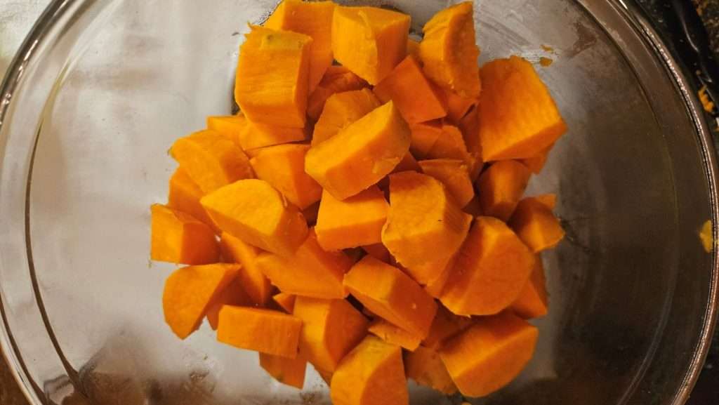 Clear bowl filled with cubed sweet potatoes